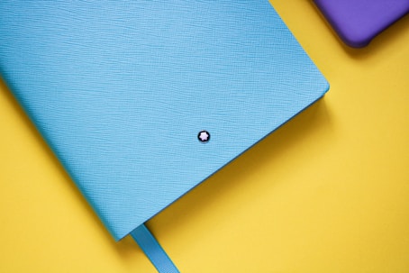 blue file  folder on yellow table