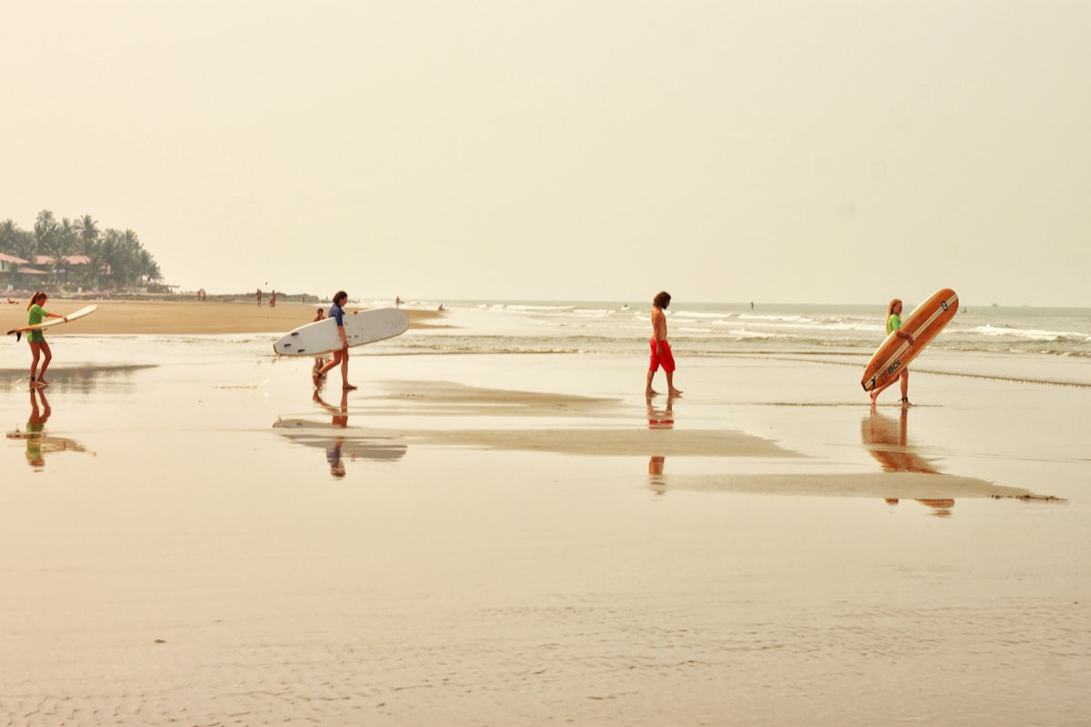 Goa October — surfer on the waves at a Goa beach as the post-monsoon season begins