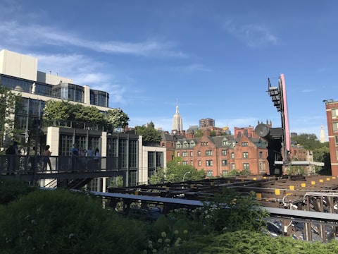 A vibrant urban neighborhood showcasing a mix of modern redevelopment and classic architecture under a clear blue sky.