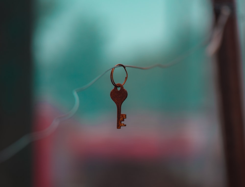 brown key chain with black and red background