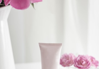 pink flower in white ceramic vase