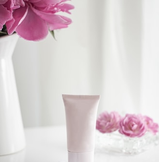 pink flower in white ceramic vase