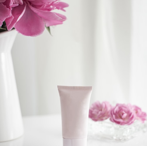 pink flower in white ceramic vase