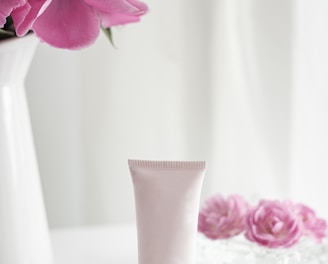 pink flower in white ceramic vase