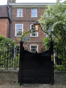 Cozy brick home with a lush garden in a quiet Gold Coast neighborhood.