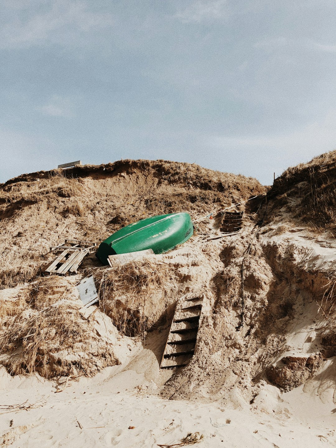 green kayak on brown rock formation during daytime