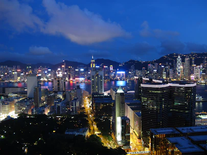 Vibrant cityscape featuring iconic landmarks and lively streets under a deep navy blue sky.