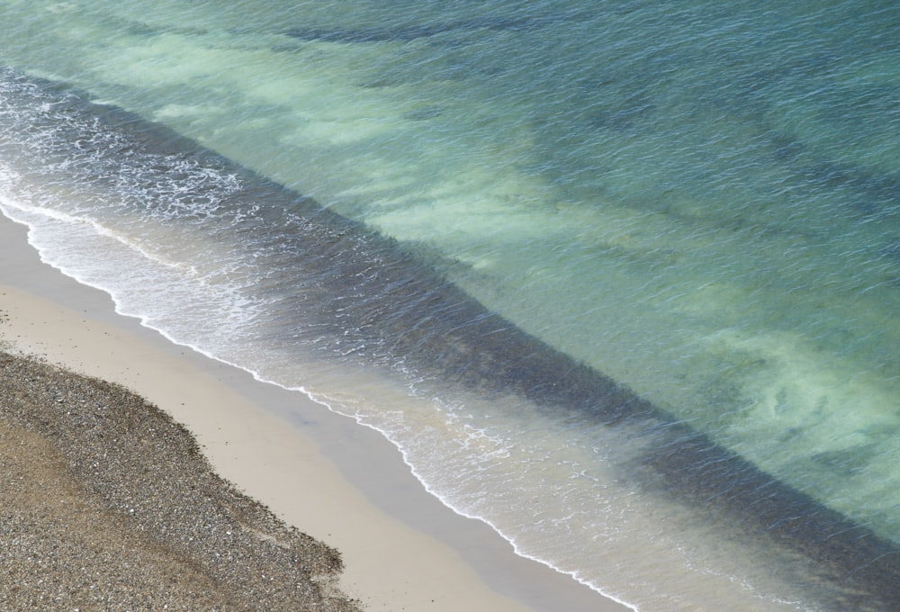 aerial view of ocean waves on shore during daytime