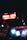 An ambulance with emergency lights flashing is visible in a dark setting. The vehicle is branded with 'Denver Health' on the side and the lights create a strong contrast against the darkness.
