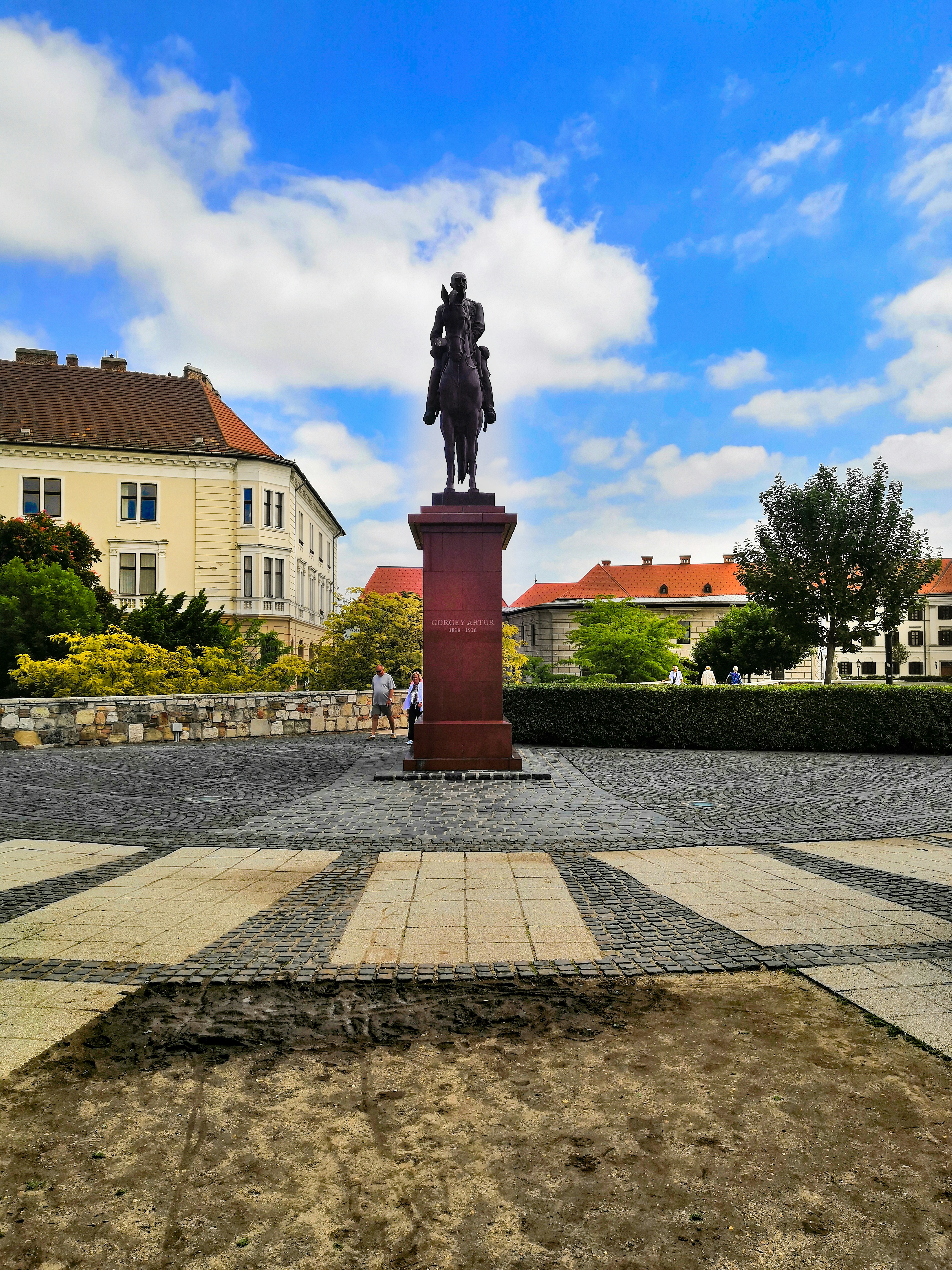 black statue of man on brown concrete post