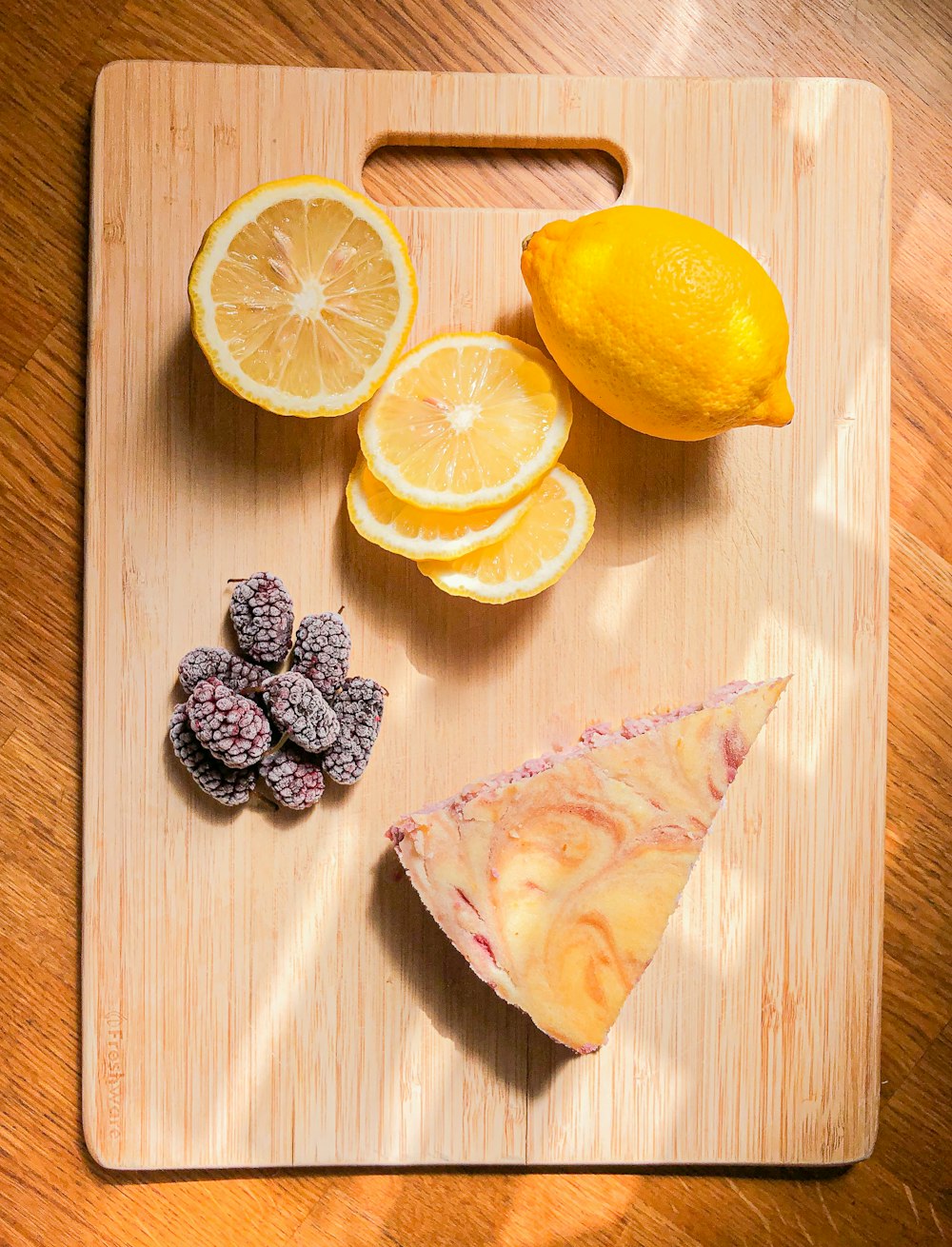 sliced lemon beside sliced lemon on brown wooden table