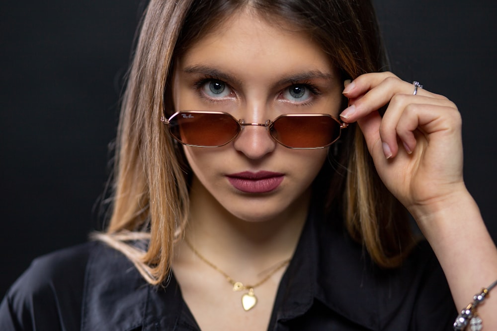 woman in black blazer wearing brown sunglasses