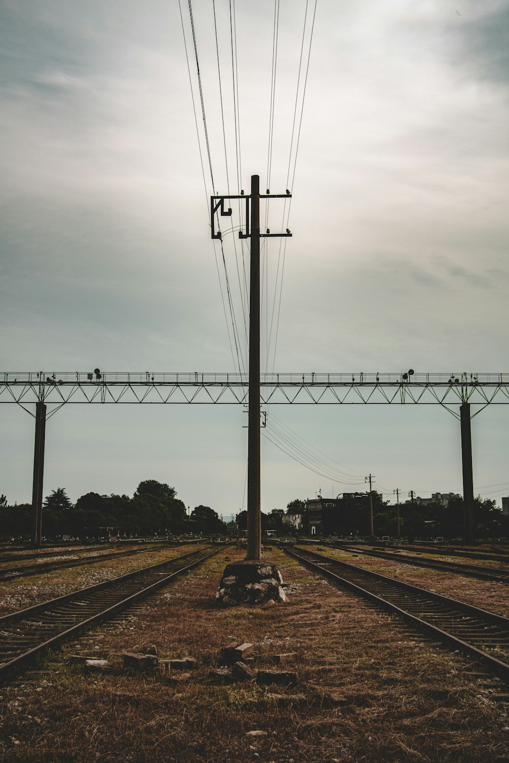 black metal electric post under gray sky