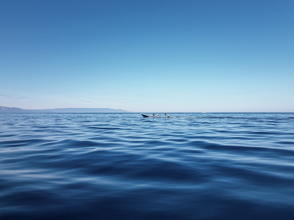 person in boat on sea during daytime