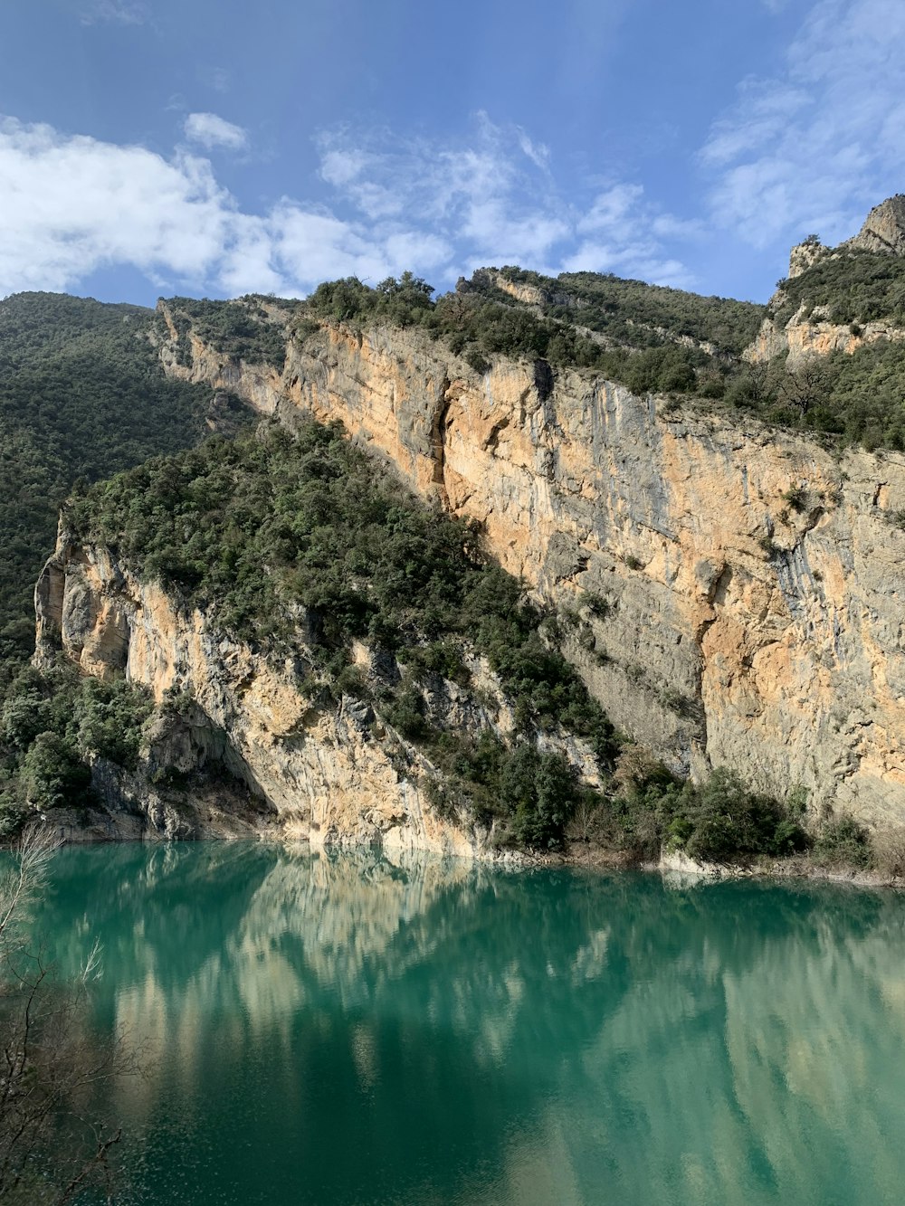 brown rocky mountain beside green water