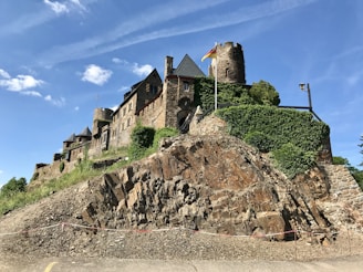 gray concrete building on top of hill during daytime