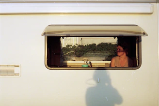 A cozy van interior with camera gear set up for filming a travel vlog.