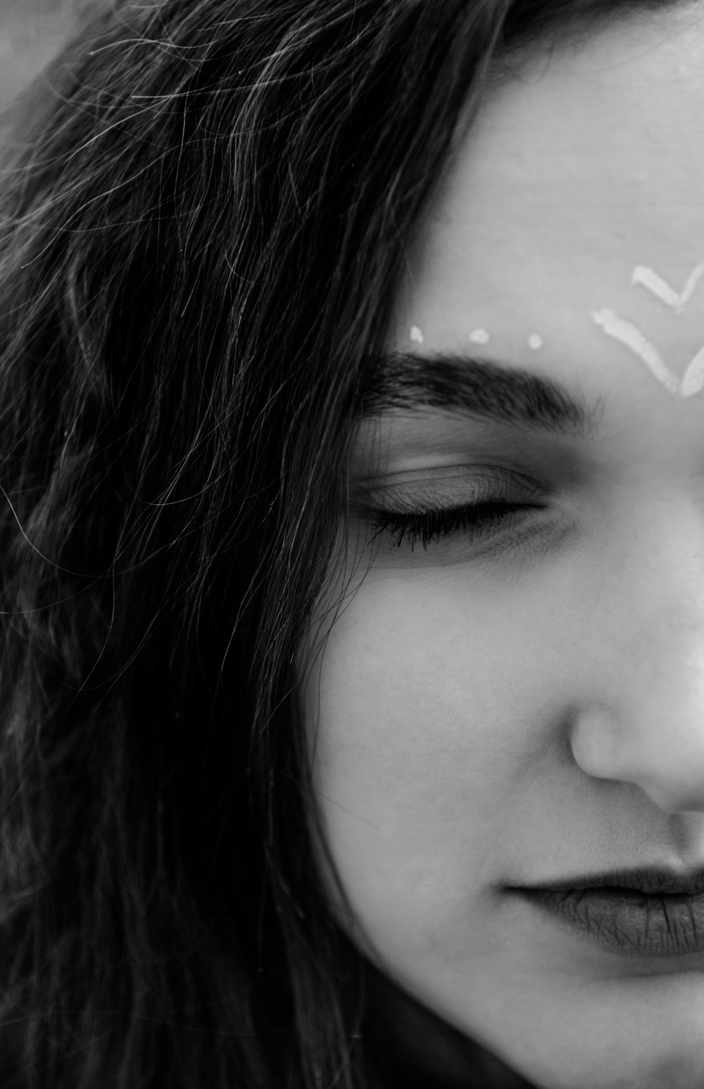 grayscale photo of woman with white and black face paint