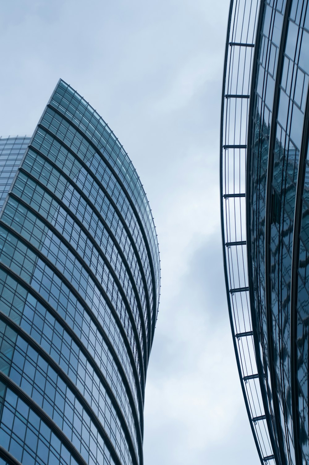 white and blue glass walled high rise building