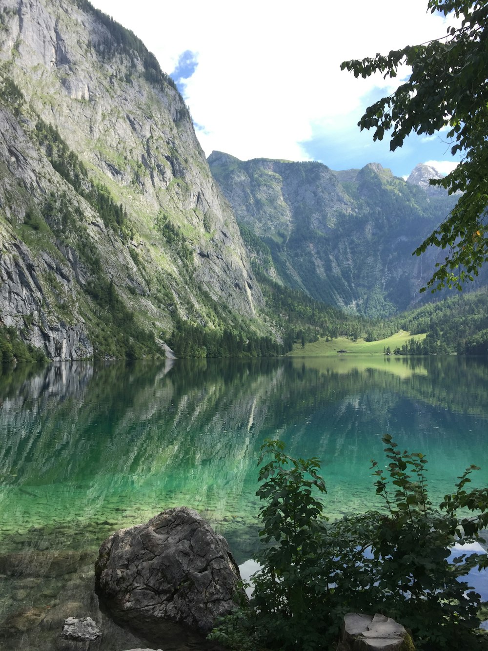 green and gray mountains beside body of water during daytime