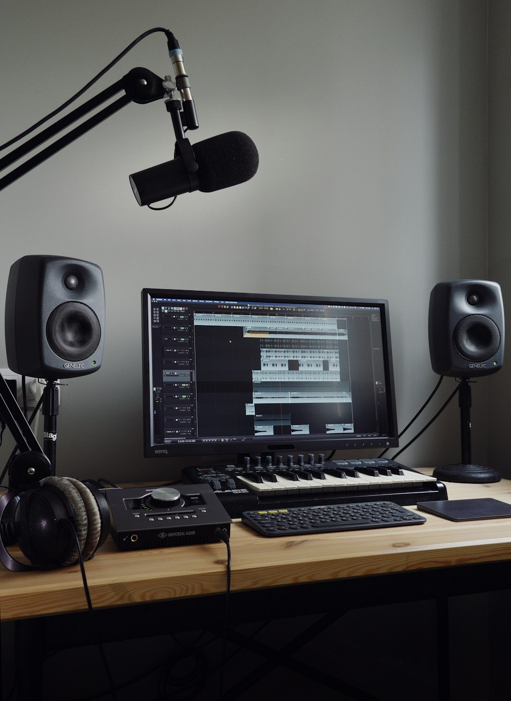 black flat screen computer monitor and black computer keyboard on brown wooden desk