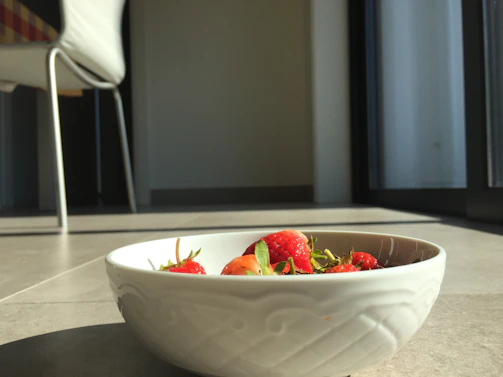 A cozy corner inside The Bowl with fresh fruit bowls and sunlight streaming through the window.