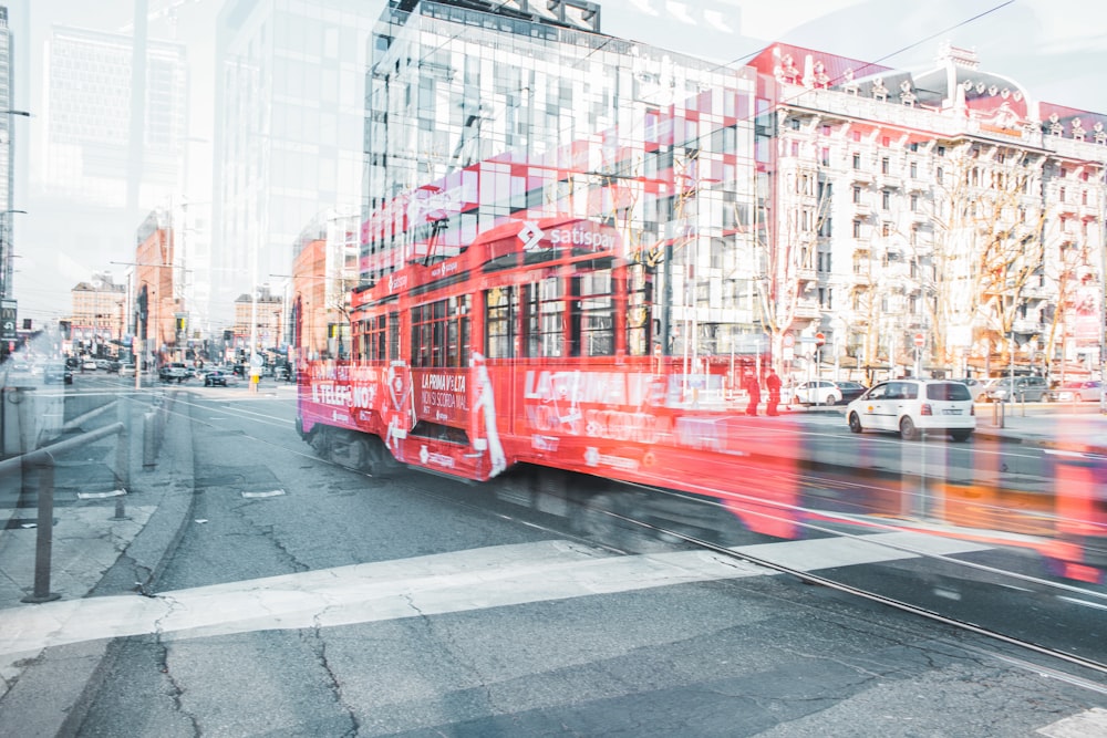 red bus on road near building during daytime