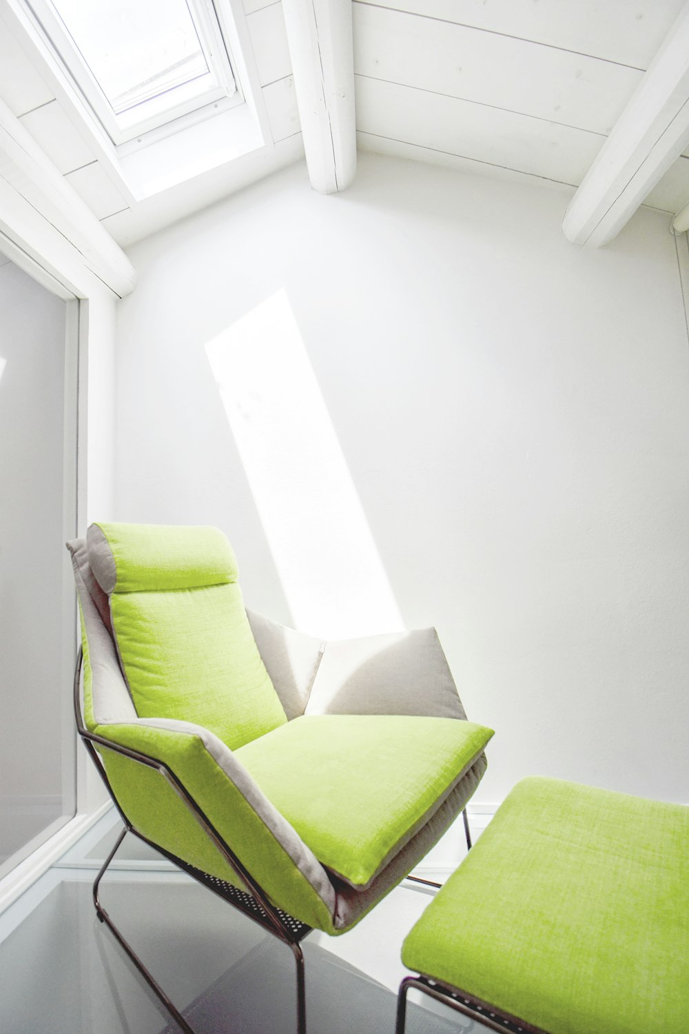 green and white padded armchair