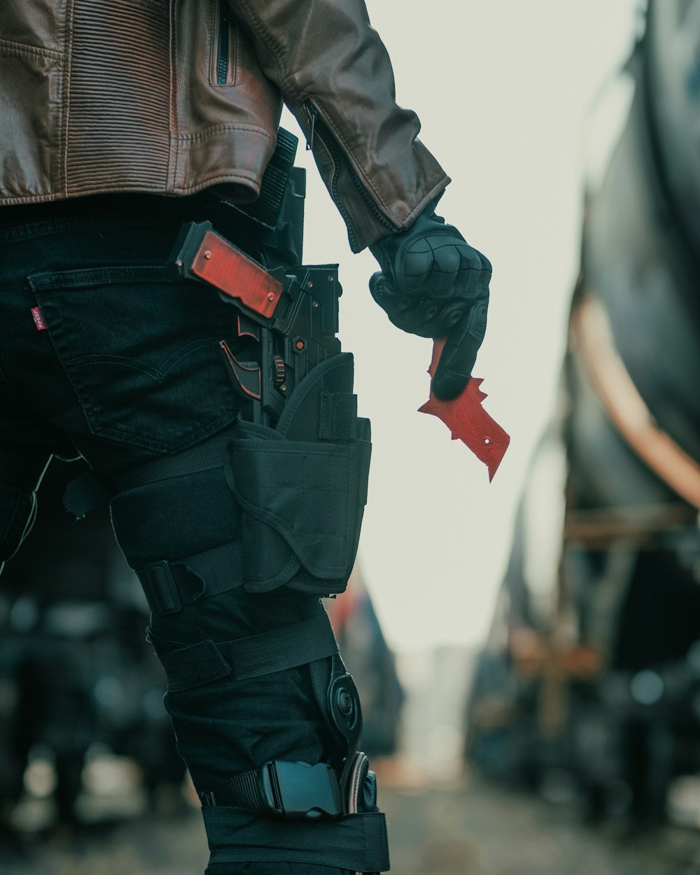 person in black leather jacket and black denim jeans