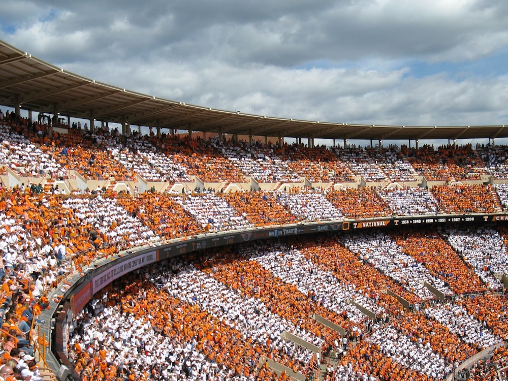 brown and white stadium under white clouds during daytime