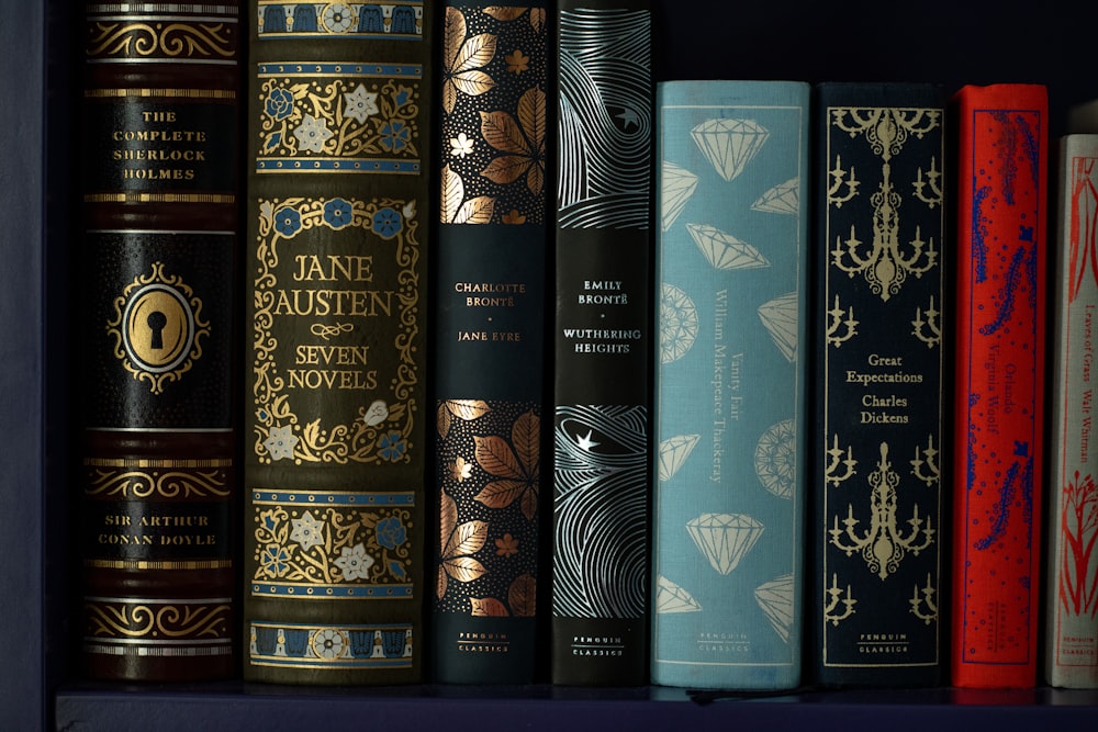 six black and gold hardbound books