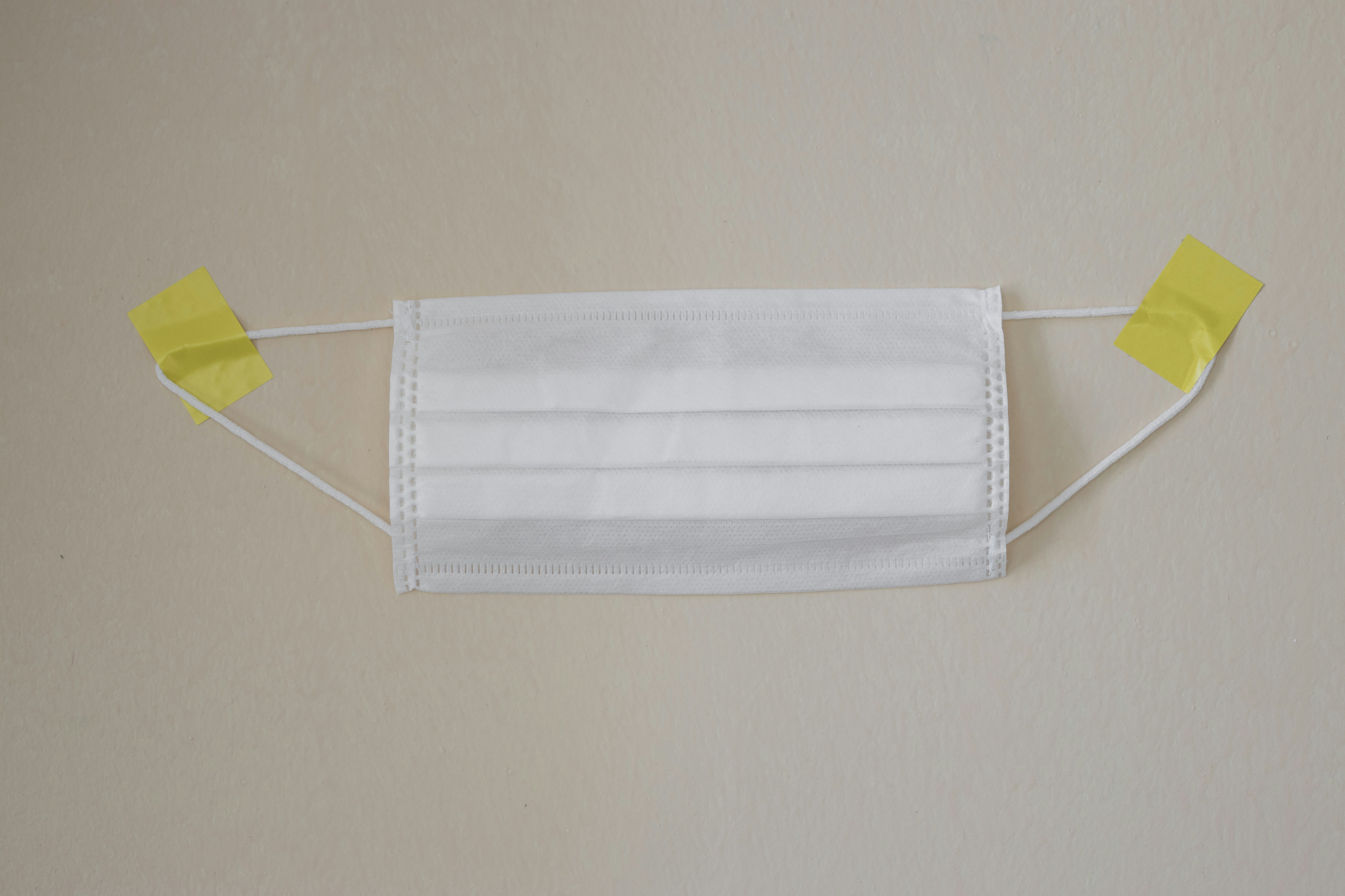 white towel on yellow clothes hanger