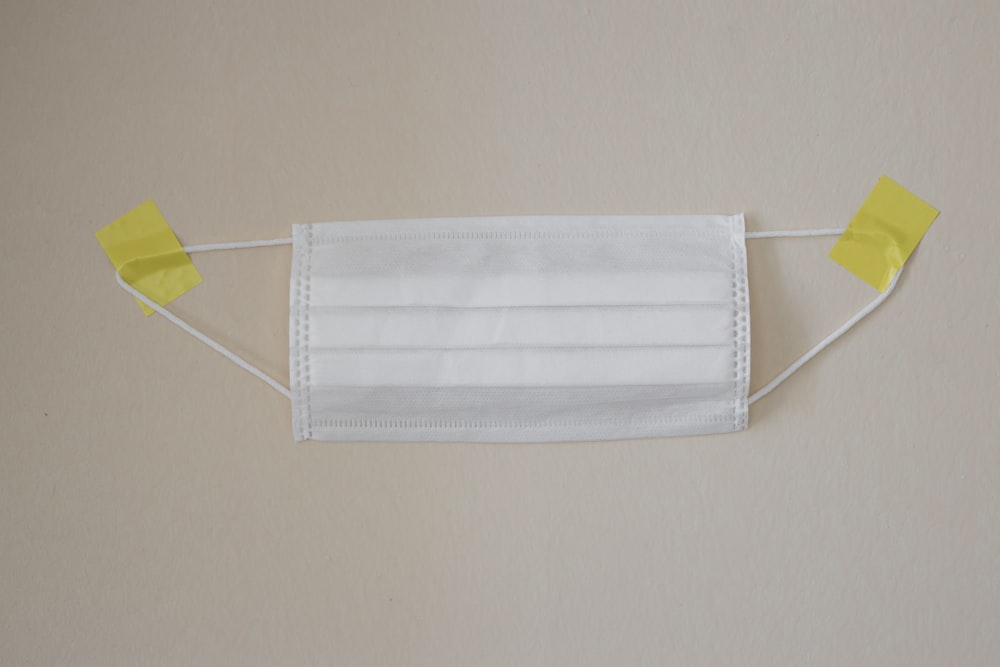 white towel on yellow clothes hanger