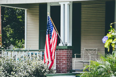 us a flag on white wooden fence