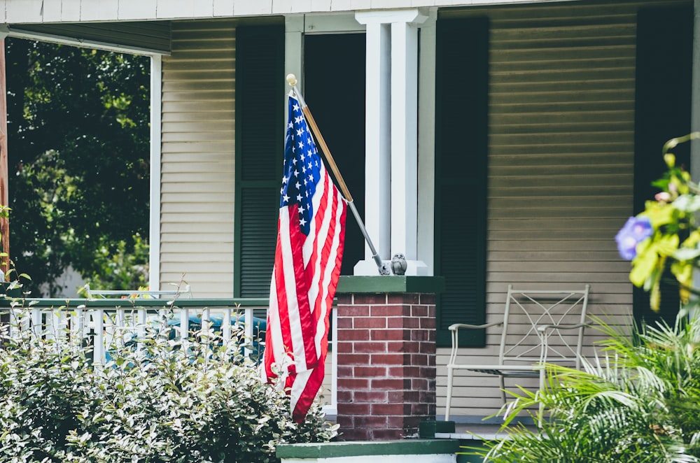 us a flag on white wooden fence