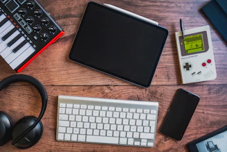 black ipad beside apple keyboard and apple magic mouse
