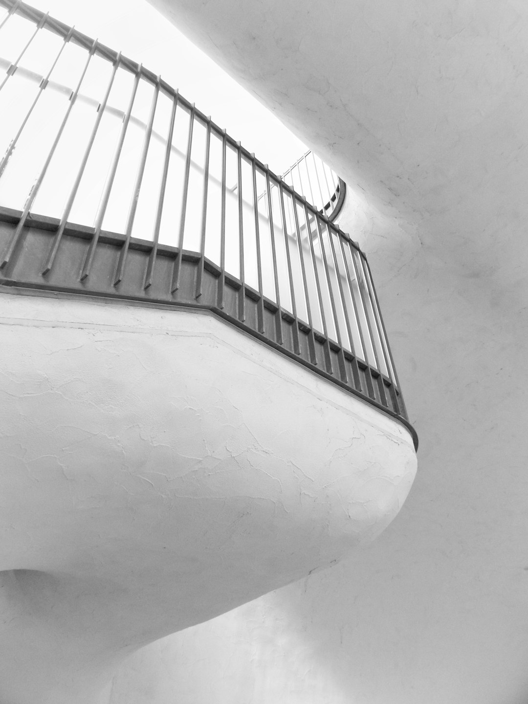 white concrete building with black metal railings