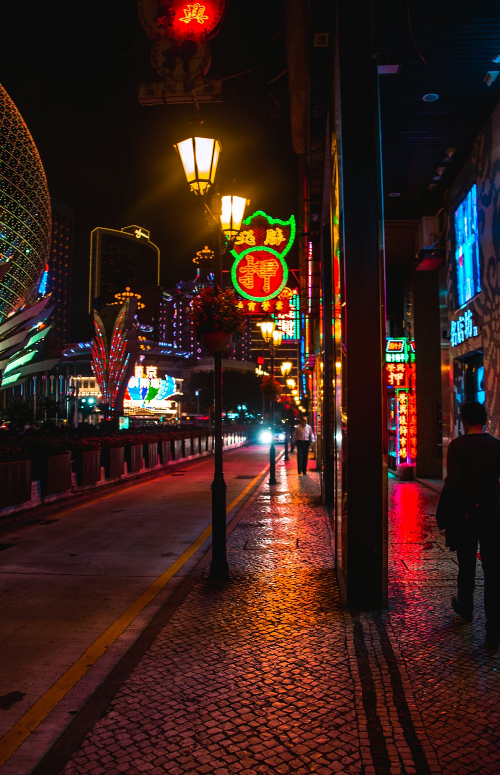 people walking on sidewalk during night time