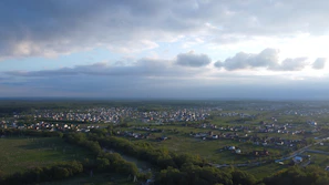 Aerial view of a small rural town with visible internet towers against a clear sky