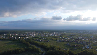 Aerial view of a small rural town with visible internet towers against a clear sky