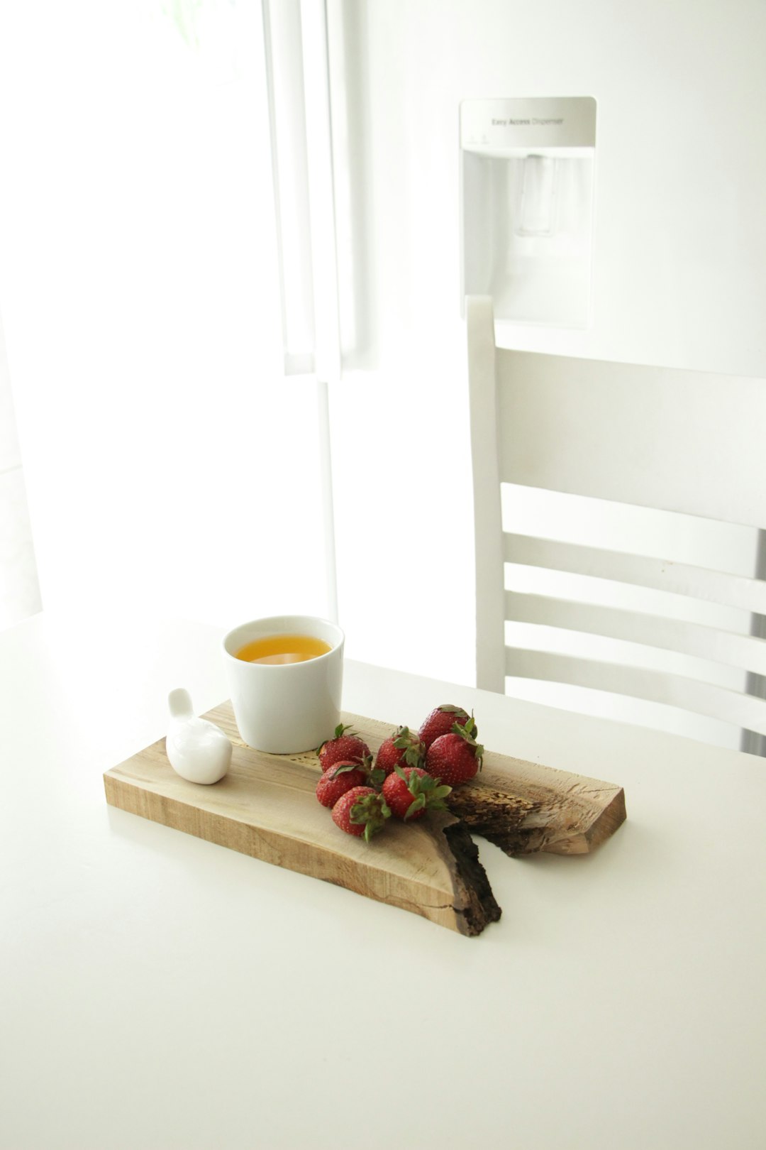 white ceramic mug on brown wooden chopping board