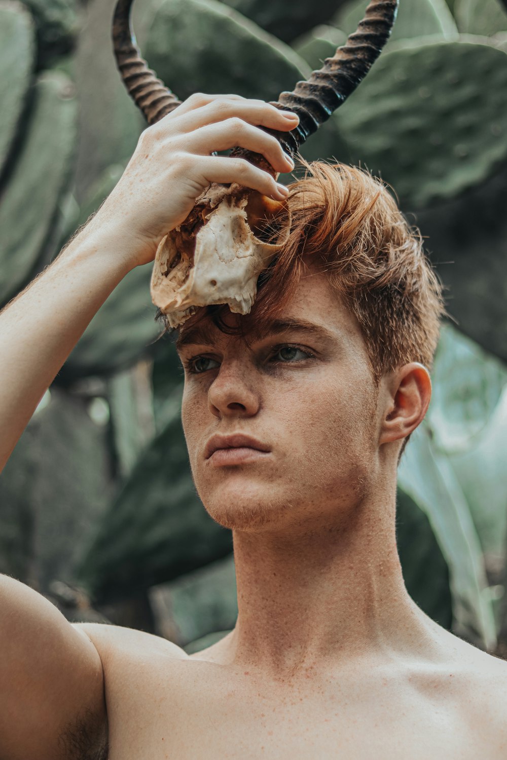 man holding brown and white stone