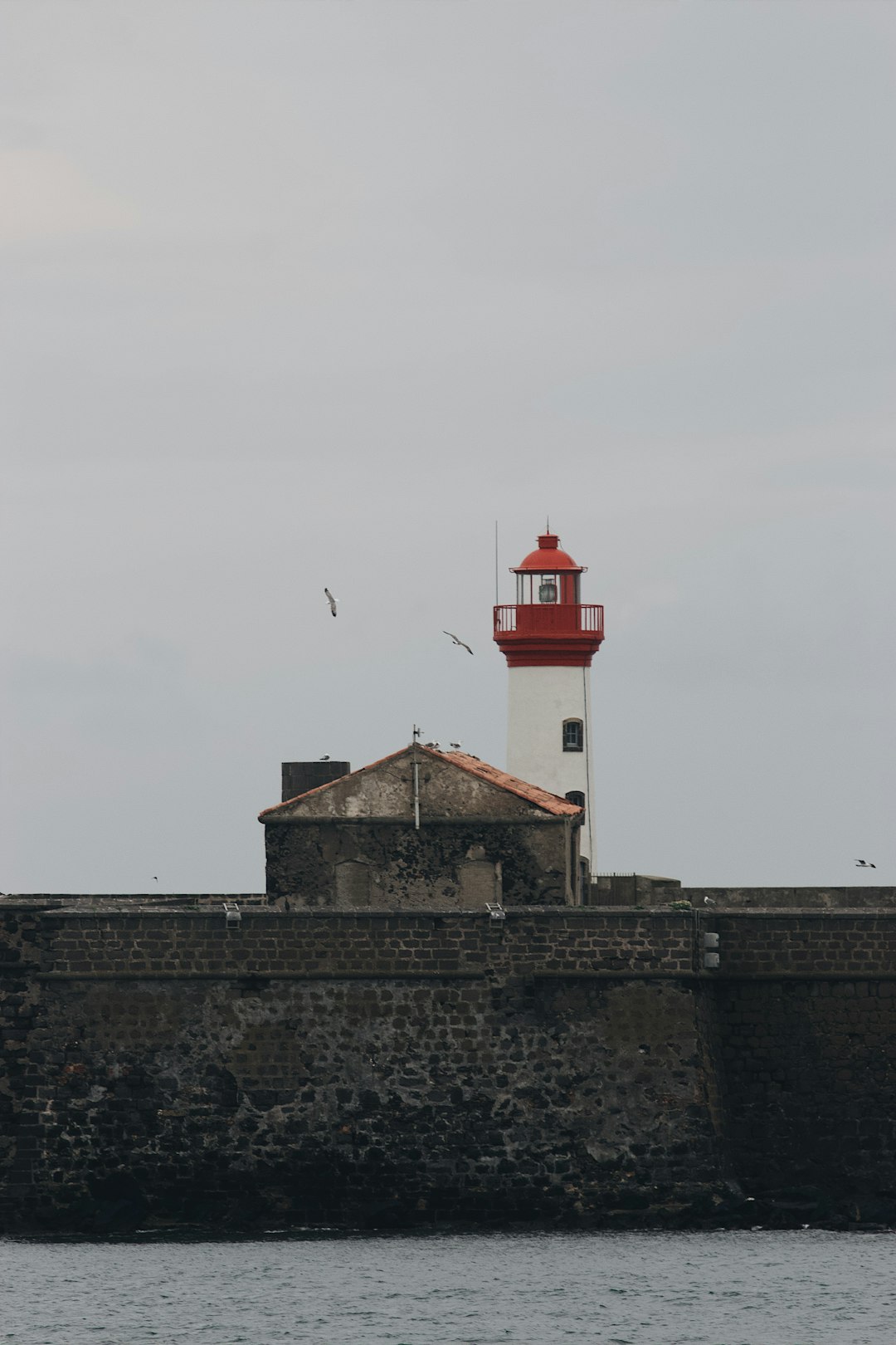 white and red concrete building under white sky during daytime