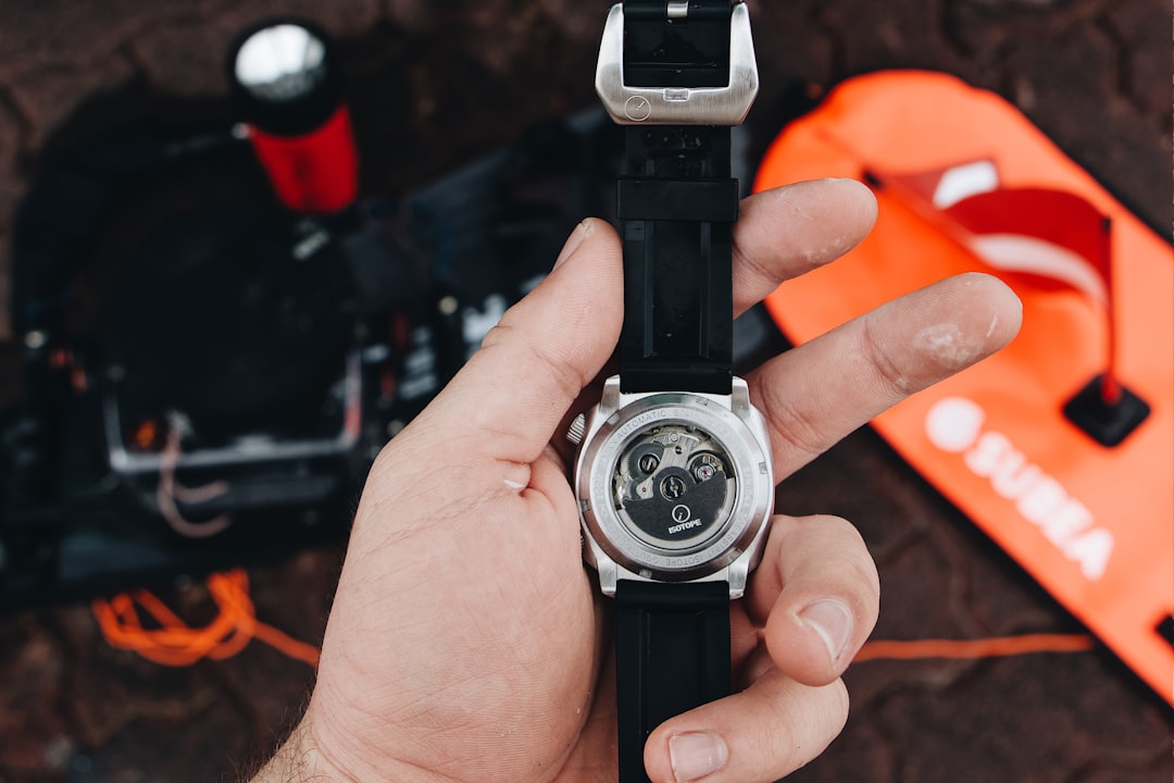 black and silver round analog watch