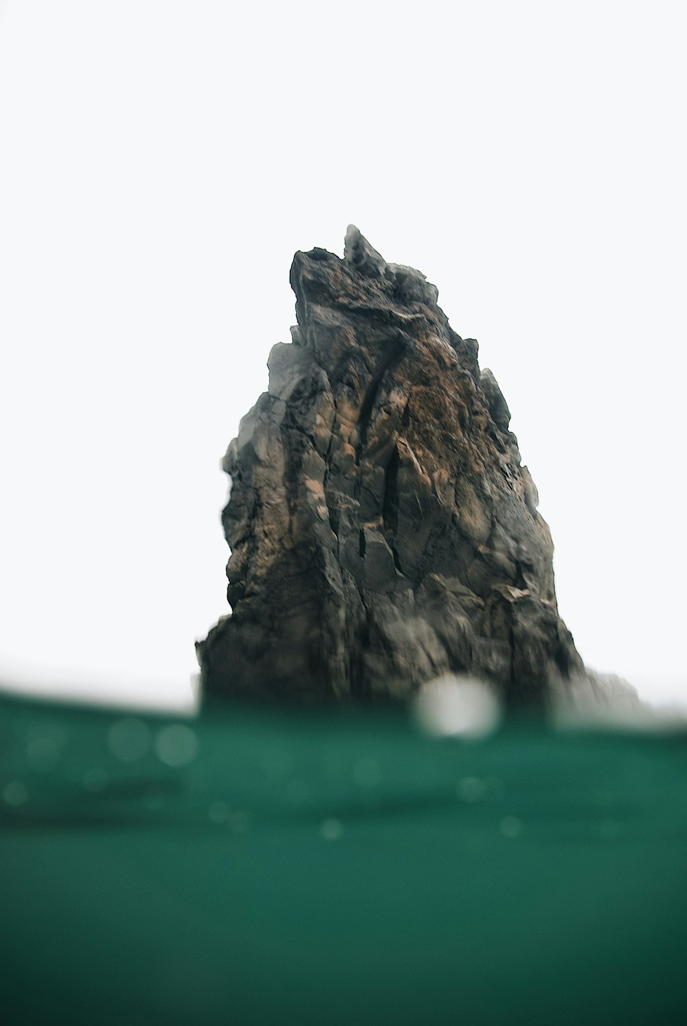 brown rock formation on water