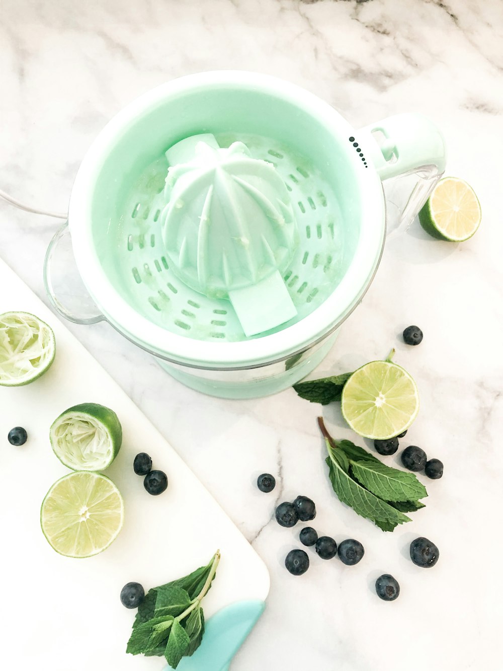 green plastic strainer beside green leaves