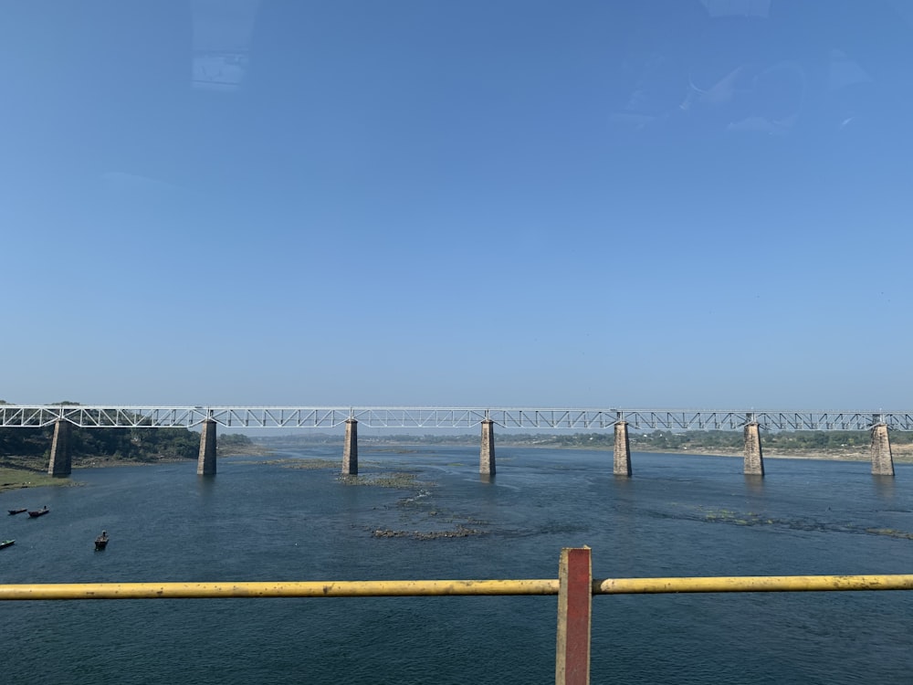 brown wooden dock on sea under blue sky during daytime