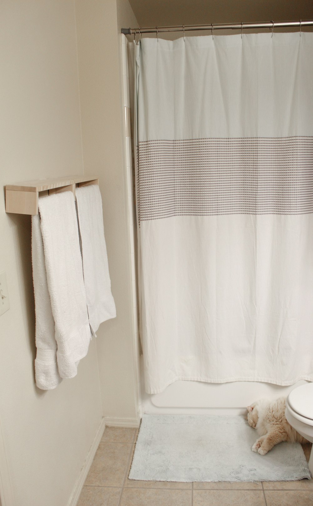 white towel on white shower curtain