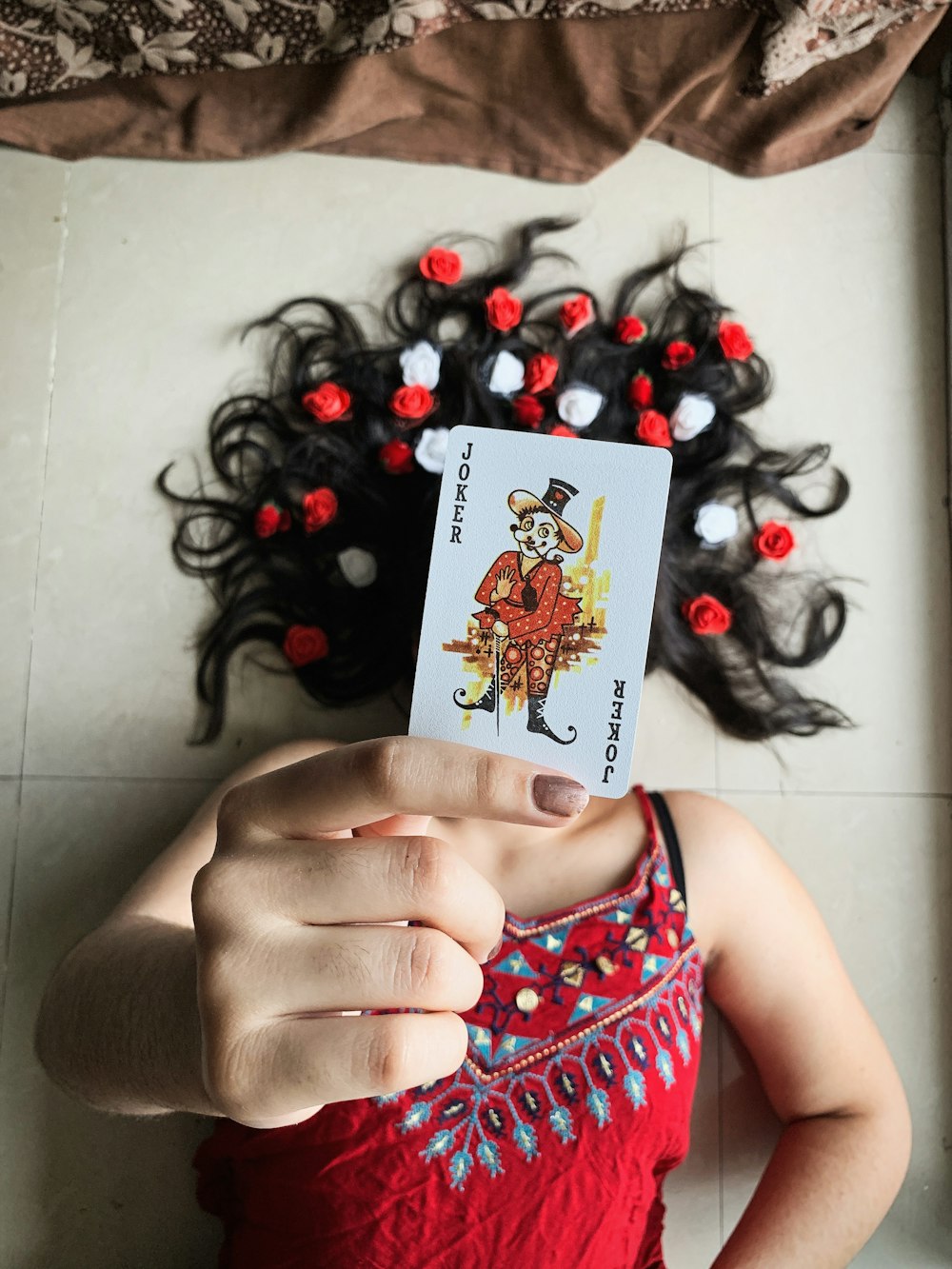 woman holding ace of diamonds playing card