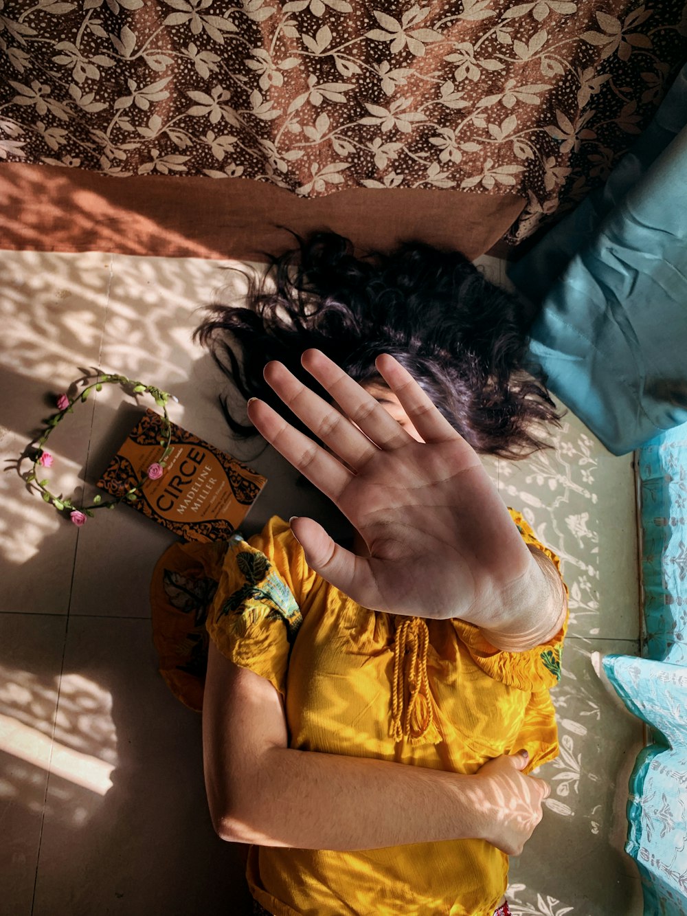 woman in yellow dress lying on bed